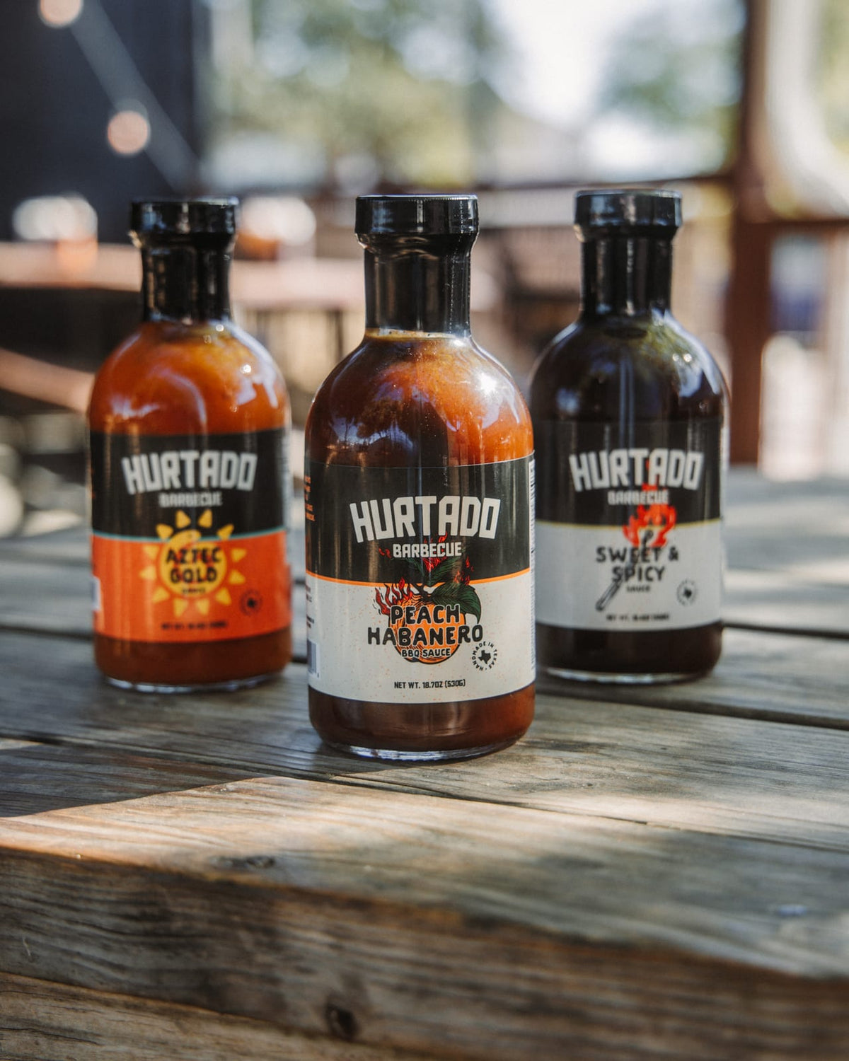 The three Hurtado sauces with Peach Habanero in front