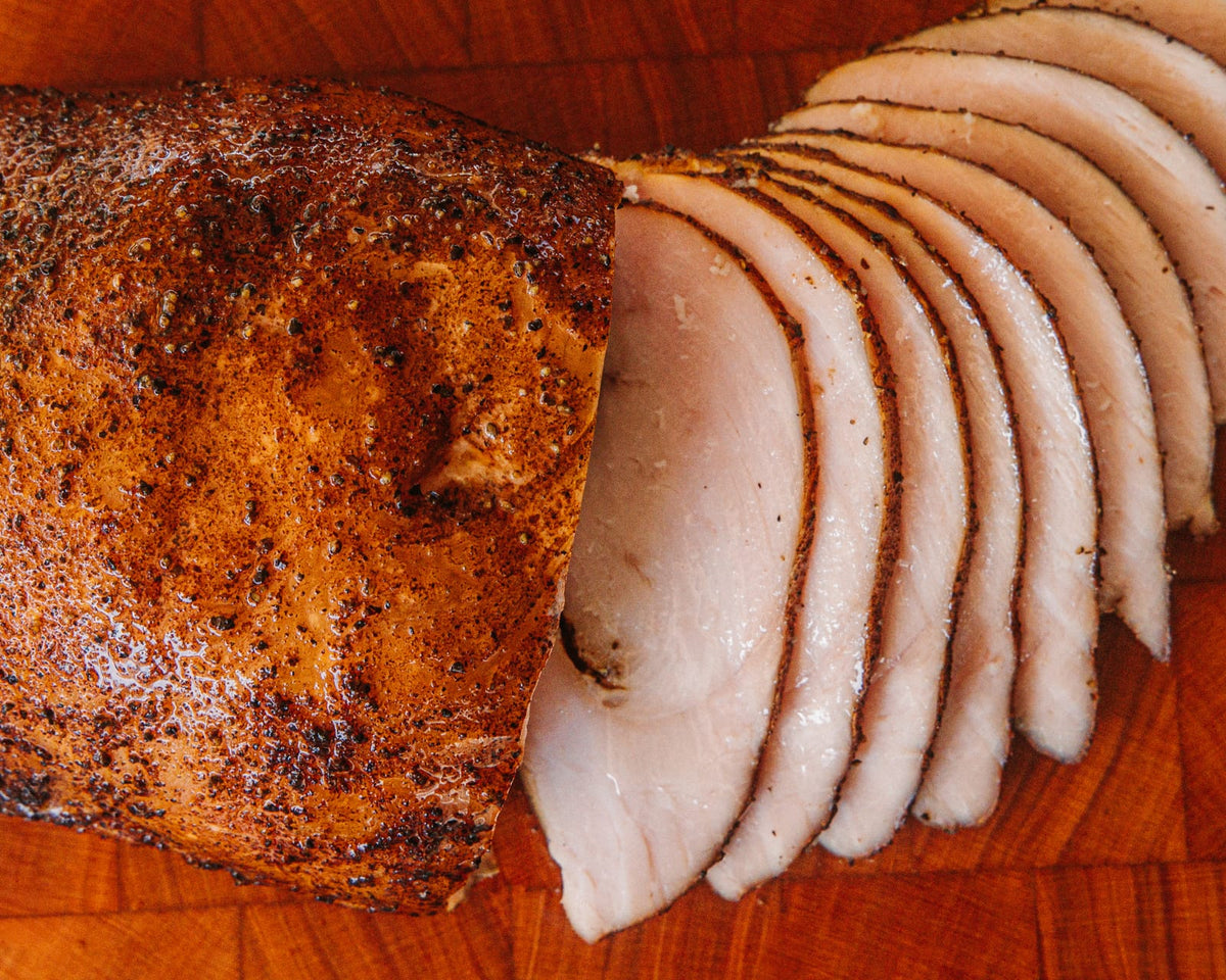 Whole smoked turkey breast, sliced at one end